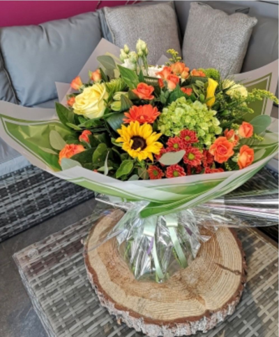 Sunshine Meadow - A bright and cheerful bouquet bursting with sunny charm and vibrant colour. Accented with lush greenery and beautifully wrapped for a polished finish, it’s perfect for celebrations, thank-you gifts, or bringing a little sunshine into someone’s day.